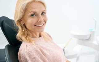 a woman smiling after receiving her dental implants in Rockwall 