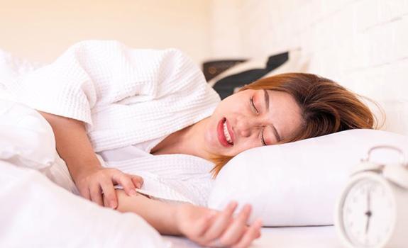 Woman grinding her teeth during sleep