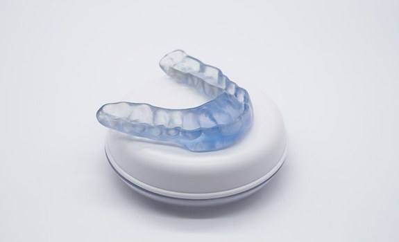 Nightguard for bruxism on top of its storage case