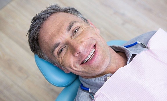 Man smiling after receiving metal-free dental restorations
