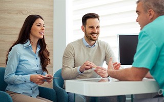 Dentist discusses matters with patients