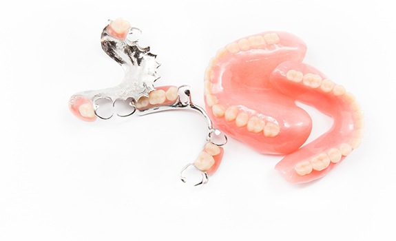 Full and partial dentures in Rockwall on white background