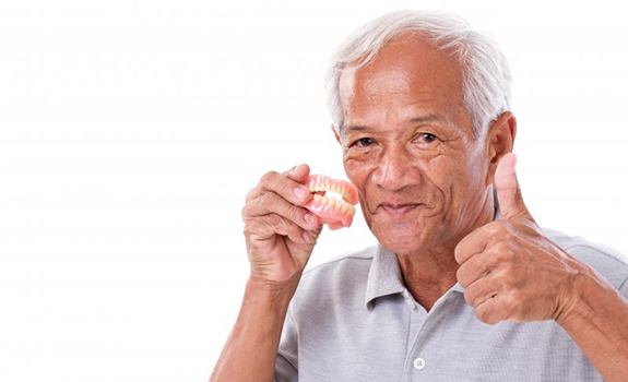 Man with dentures in Rockwall gives thumbs up