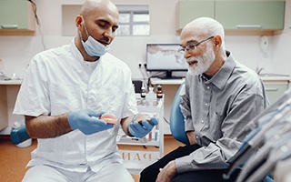 A dentist and patient discussing denture candidacy