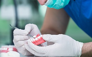 A dental technician slowly making dentures