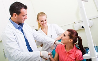 Woman shaking hands with Rockwall emergency dentist