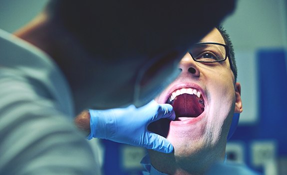 Emergency dentist in Rockwall examining a patient’s mouth