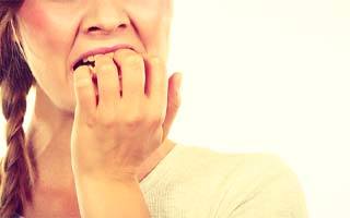 Woman biting her fingernails