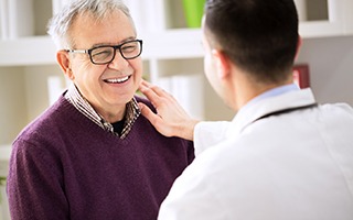 Patient and dentist discussing how to make dental implants affordable in Rockwall 