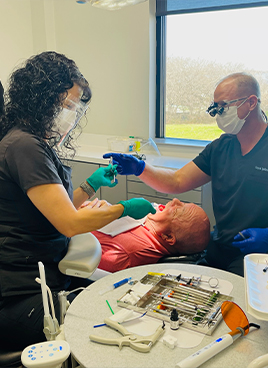 Man smiling after replacing missing teeth