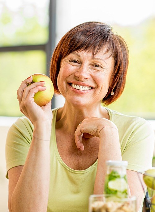 Woman sharing healthy smile after gum disease treatment