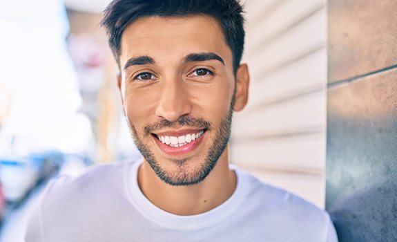 Young man enjoying a healthy smile thanks to preventive dental care