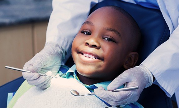 Child in dental chair receiving children's dentistry treatment