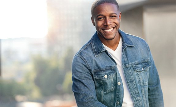 man smiling after getting root canal therapy in Rockwall