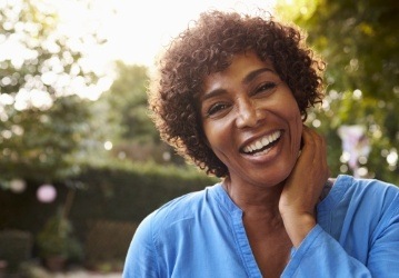 Woman smiling after restorative dentistry treatment