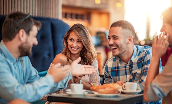 Group of friends smiling at a restaurant