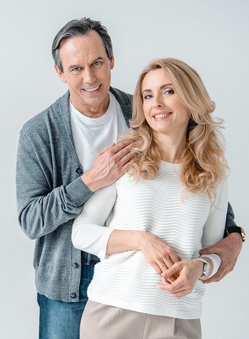 Smiling man and woman at dental office