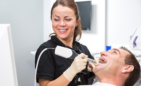 Dental team member capturing smile images with intraoral camera