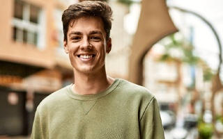 man smiling after getting tooth-colored filling in Rockwall