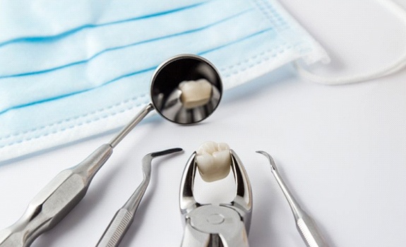Dental tools holding tooth after tooth extraction in Rockwall