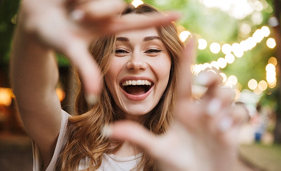 woman using fingers to frame smile