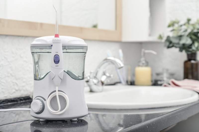 A Waterpik by a sink