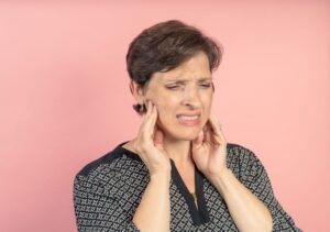 Middle-aged woman suffering from TMJ pain