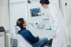 Dentist showing patient an X-ray.
